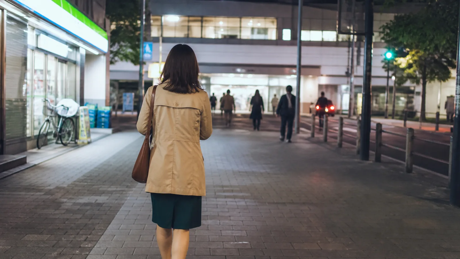仕事を終えて明るい駅へ向かう応募者の後ろ姿